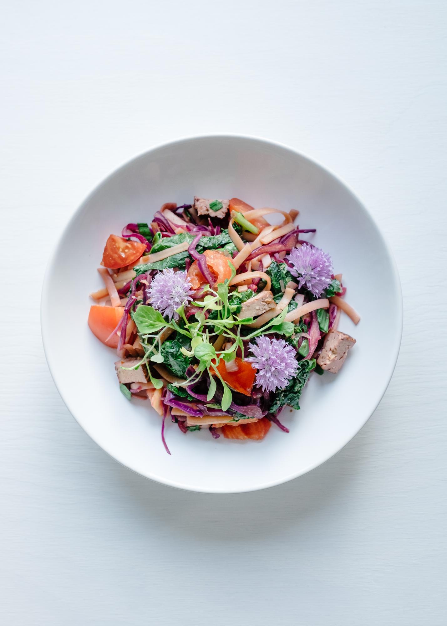Close-up of a plated salad with edible flowers